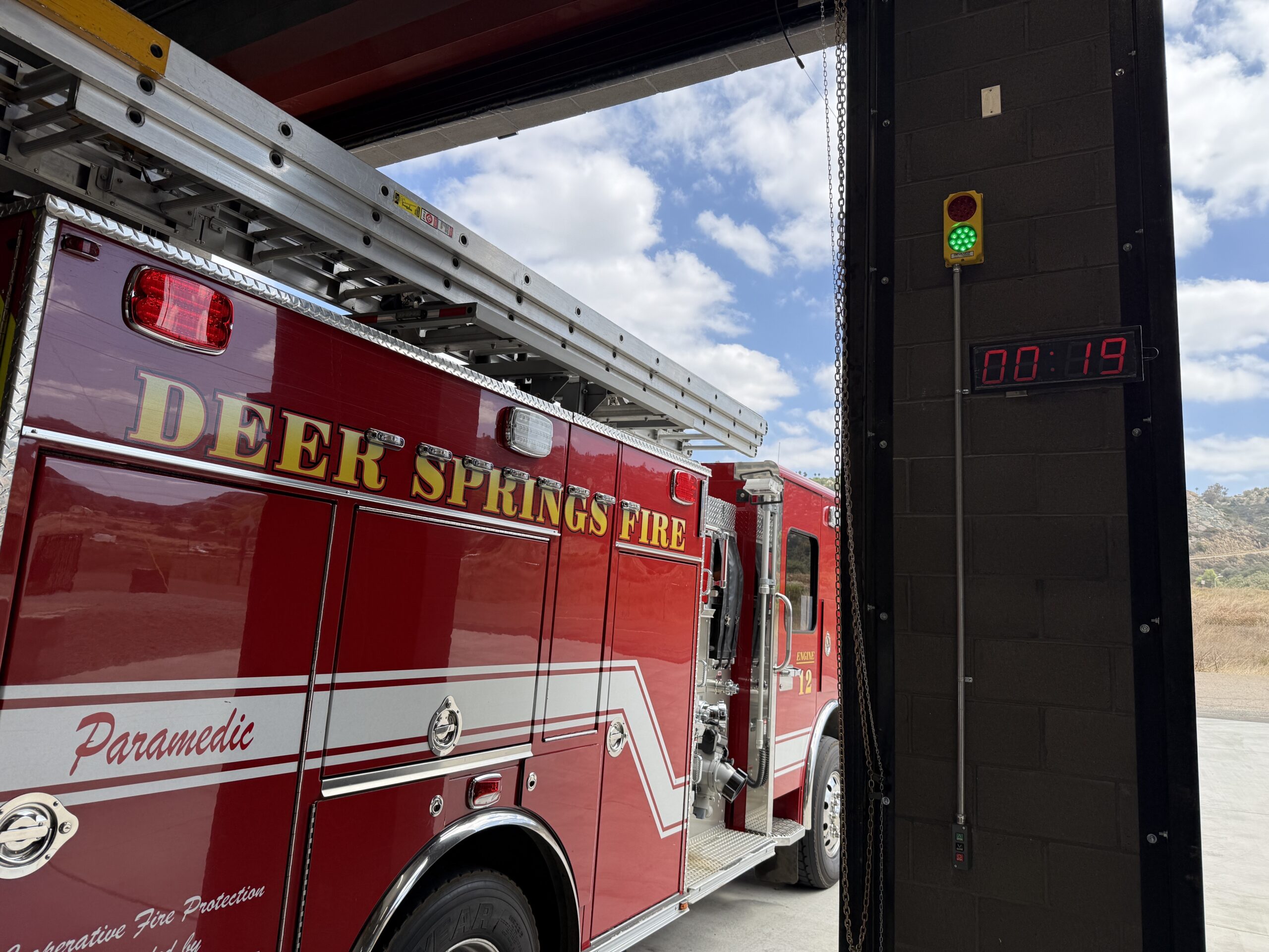 image (60) Deer Springs Fire Protection District fire engine beside a digital turnout timer and station alert light